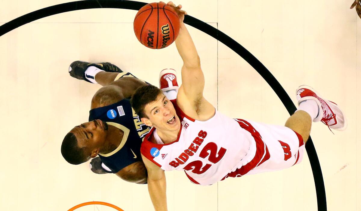 Wisconsin's Ethan Happ tries to grab a rebound against Pittsburgh's Michael Young during the first half.
