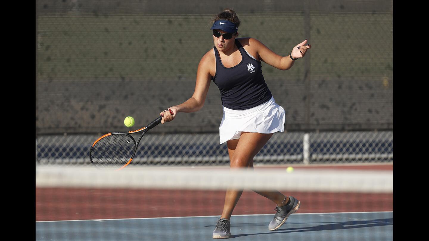 Newport Harbor's Nicole Knickerbocker returns a forehand during a match against Los Alamitos in a Sunset League game on Thursday, October 12.
