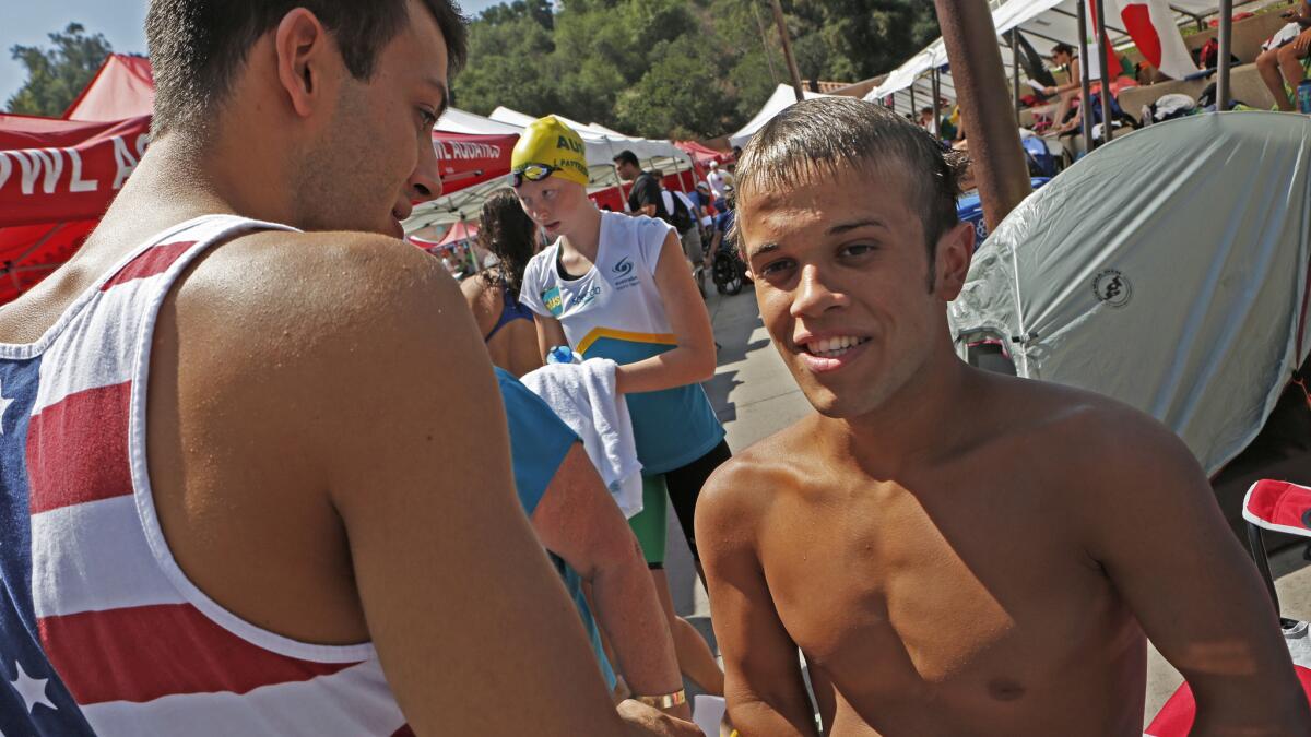Lucas McCrory, right, is congratulated by his older brother Nick McCrory after competing in the men's 50-meter butterfly at the 2014 Pan Pacific Para-Swimming Championships at Rose Bowl Aquatics Center on Aug. 6.