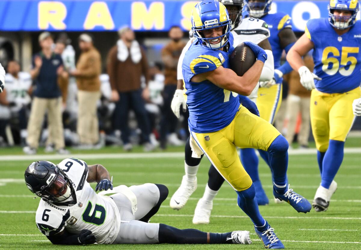 Rams' Cooper Kupp catches a short pass and runs past Seattle's Quandre Diggs (6).