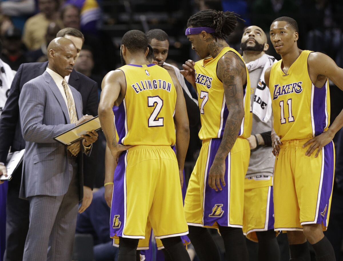 Lakers Coach Byron Scott draws a play for the Lakers during a timeout in the second half of a game against the Hornets.