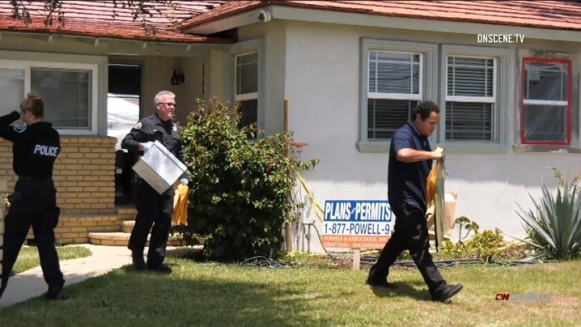 Investigators remove evidence from a home in Downey.