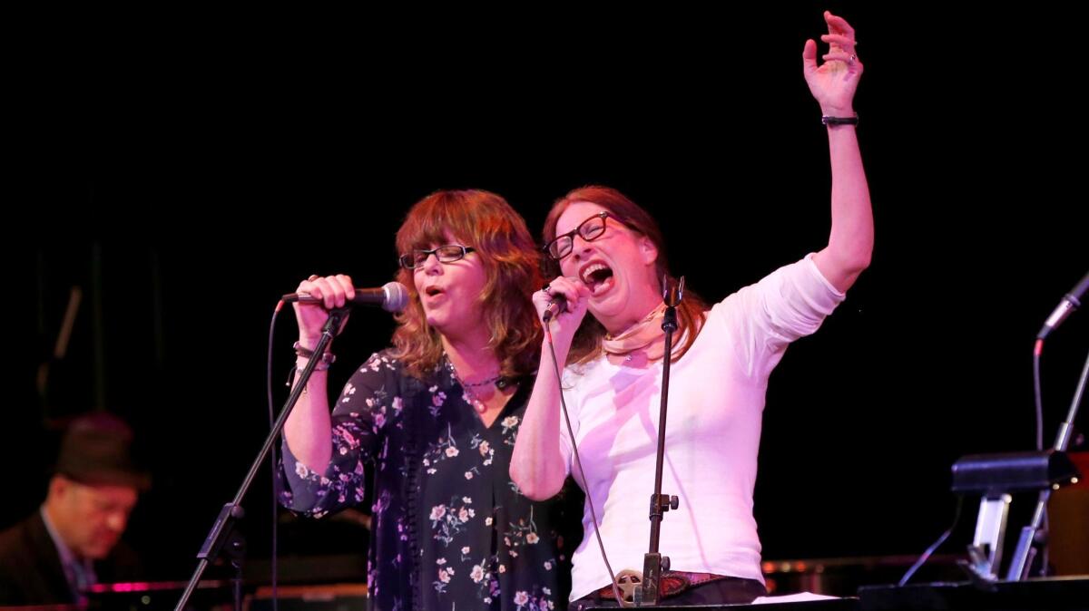 Singers Susan Cowsill, left, and Syd Straw at Saturday's tribute to the Band in Glendale, benefiting the Autism Think Tank. (Allen J. Schaben / Los Angeles Times)