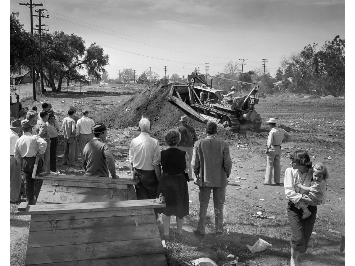 April 11, 1949: A bulldozer fills up holes dug during the operation.