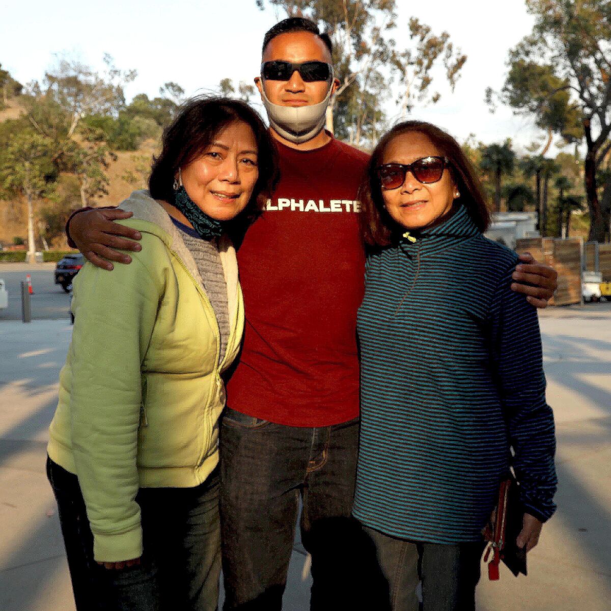 A man and two women pose for a photo.