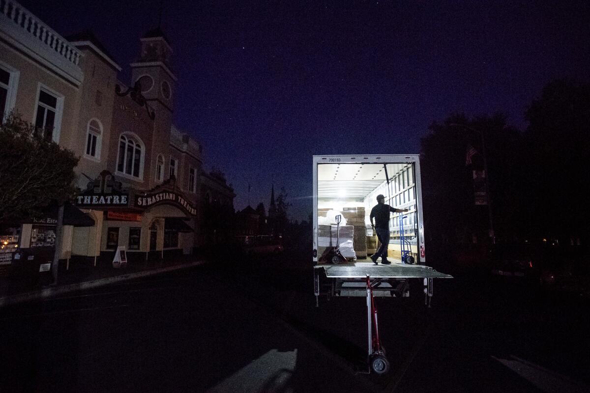 Armando Espinoza delivers paper products to a cafe in downtown Sonoma, Calif., where power was turned off, on Oct. 9. Pacific Gas & Electric cut power to more than half a million customers in Northern California, hoping to prevent wildfires during dry, windy weather throughout the region.