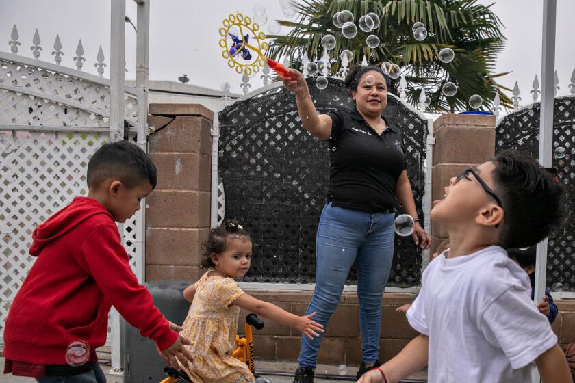 Los Angeles, CA - May 22: Adriana Lorenzo brings out bubbles for her students during play time at her Boyle Heights home day care center on Monday, May 22, 2023 in Los Angeles, CA. (Jason Armond / Los Angeles Times)