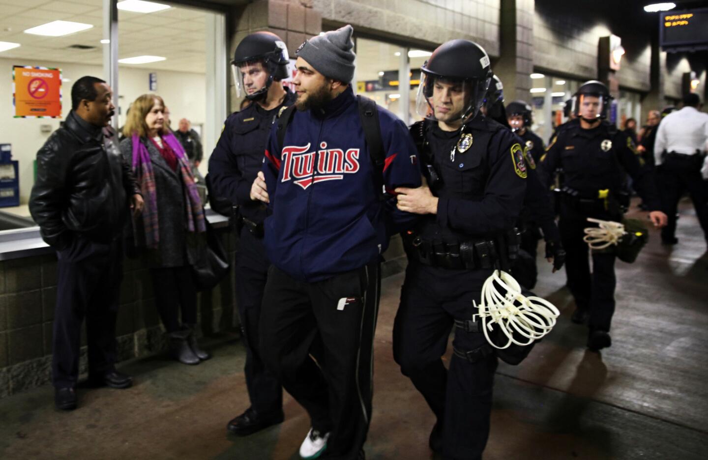 Police officers detain a protester at the Mall of America on Dec. 23, 2015, in Bloomington, Minn.