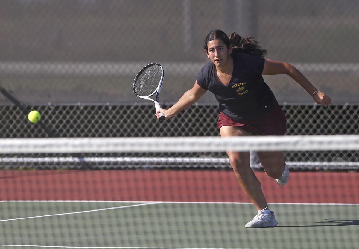 Estancia's Victoria Vega runs to hit a shot against rival Costa Mesa earlier this season.