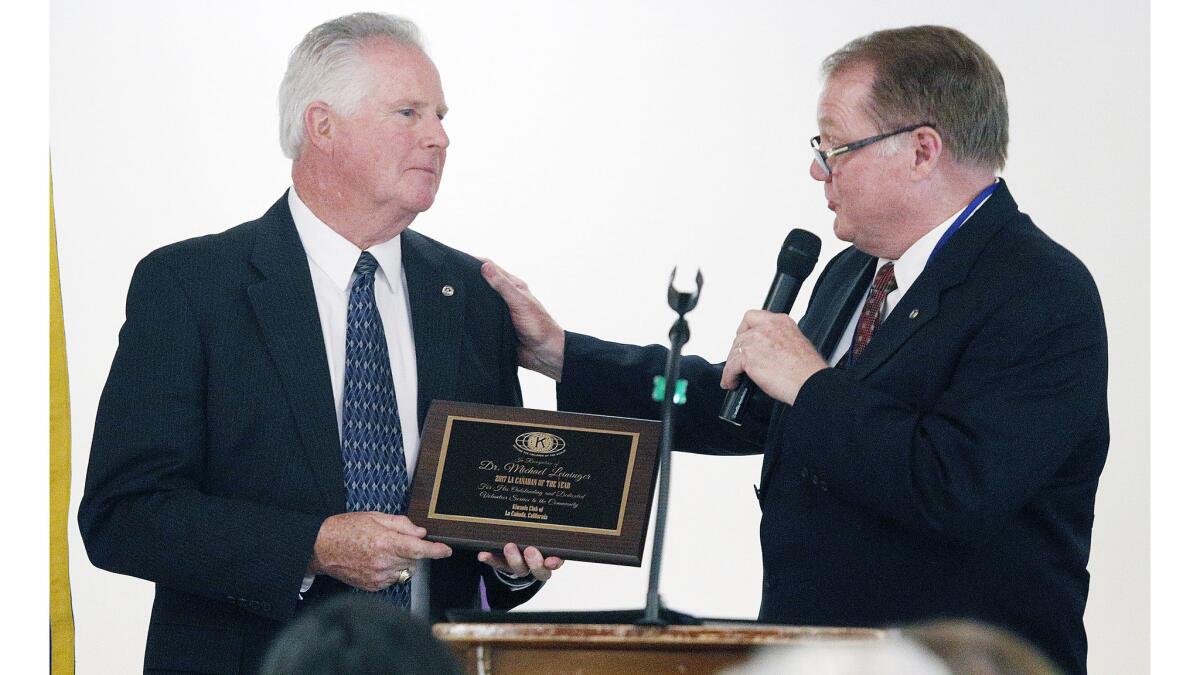 Kiwanis President Chuck Terhune gives Michael Leininger his award as the 2017 La Cañadan of the Year on Wednesday.