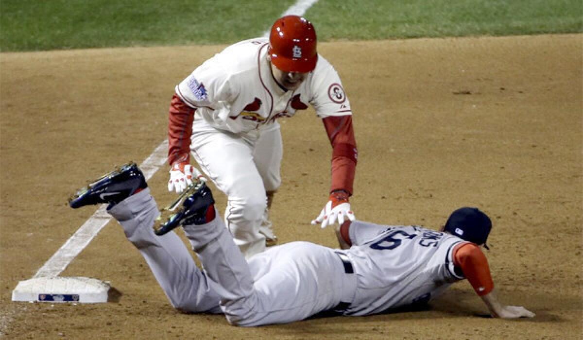 St. Louis' Allen Craig gets tangled with Boston's Will Middlebrooks during the ninth inning of Game 3 of the World Series. Middlebrooks was called for obstruction on the play and Craig went in to score the game-winning run.