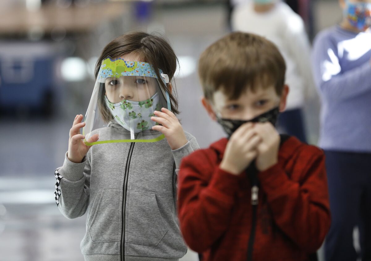 Kindergarten students of teacher Ursula Dysthe wear face protection at Lupin Hill Elementary School in Calabasas.