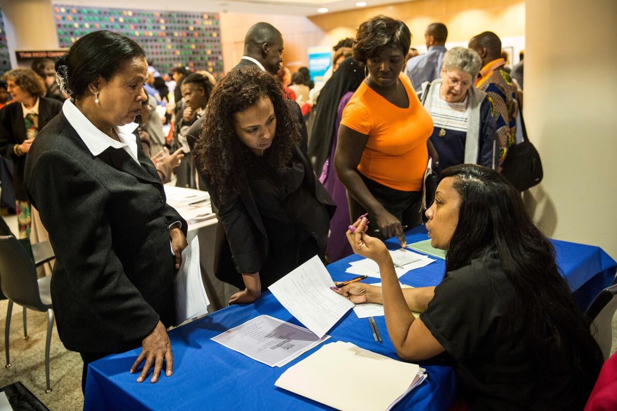 People attend a job fair at the Bronx Public Library on Sept. 17 in New York City.