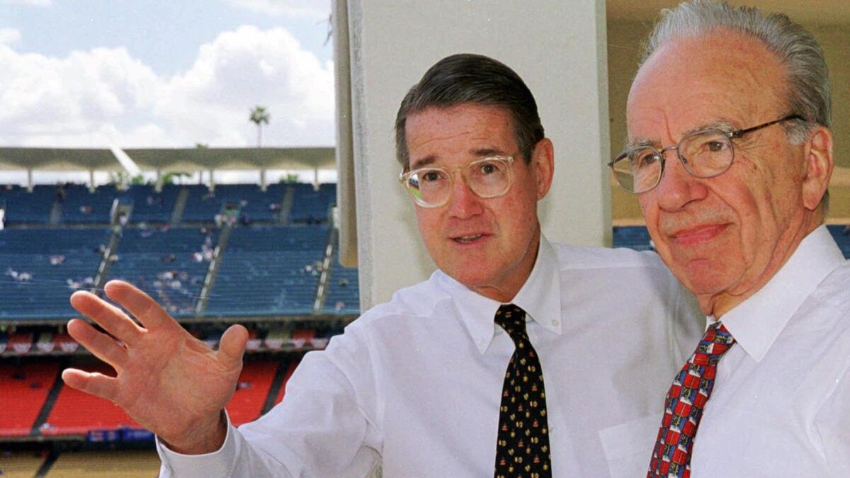 Former Dodgers owner Peter O'Malley, left, and new owner Rupert Murdoch look over the playing field during Opening Day in Los Angeles on April 7, 1998.