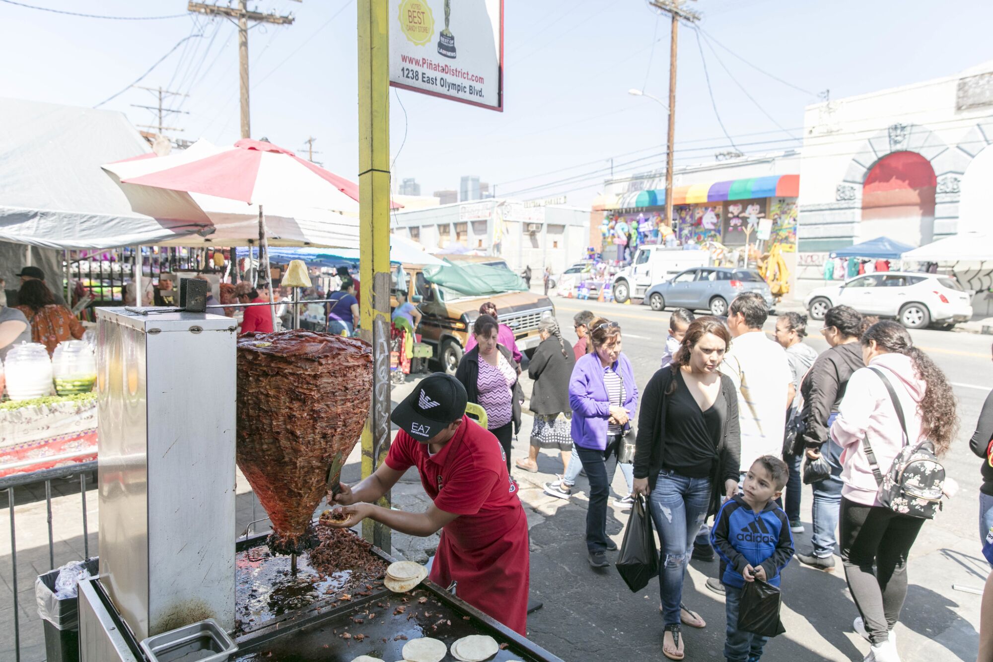 Tobias Martinez of Tacos el Chivo cuts meat for tacos al pastor at the Piñata District.