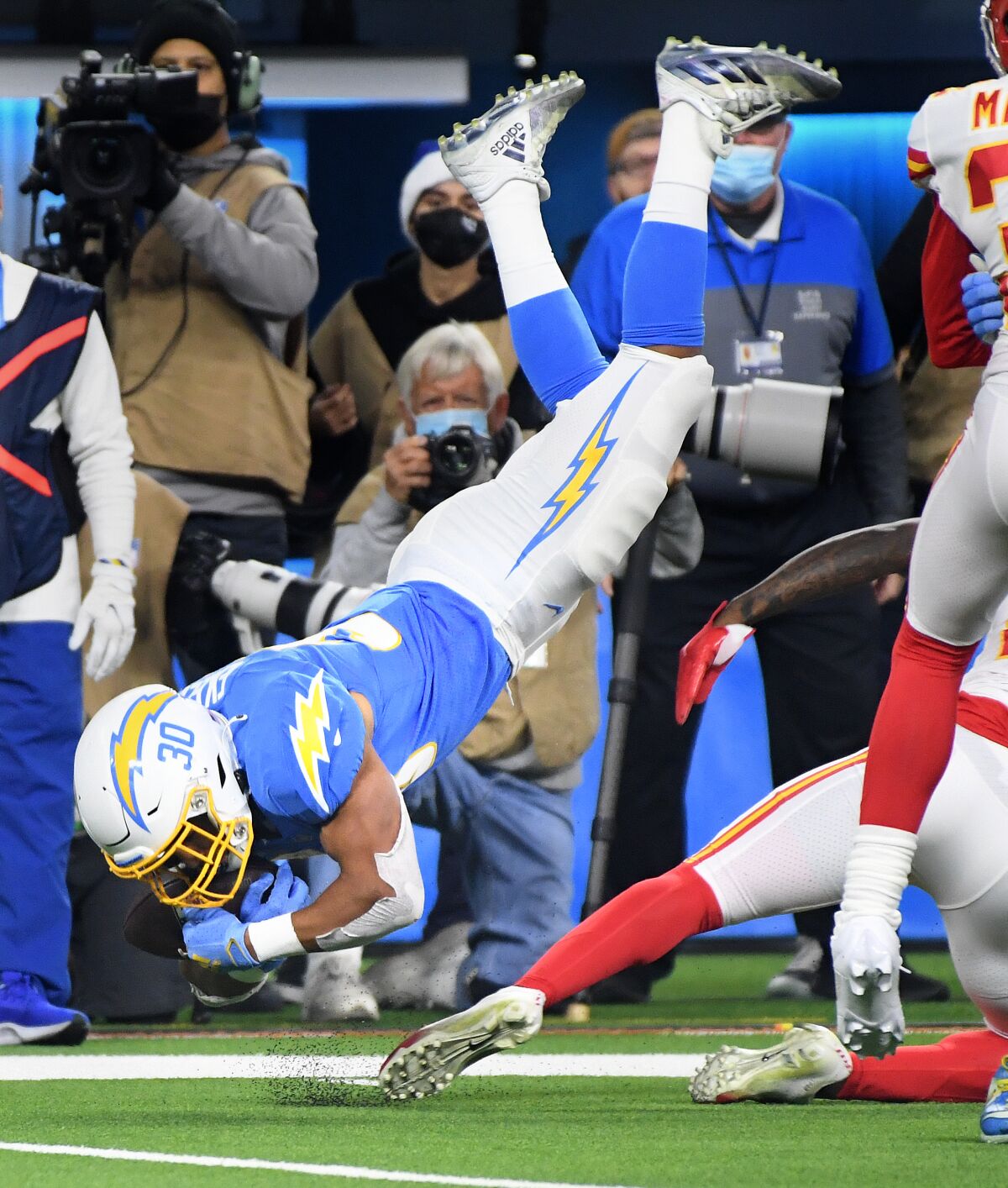 Chargers running back Austin Ekeler is upended during a carry in the second quarter.