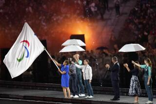 Mayor of Los Angeles Karen Bass holds the Paralympic flag during the closing ceremony.