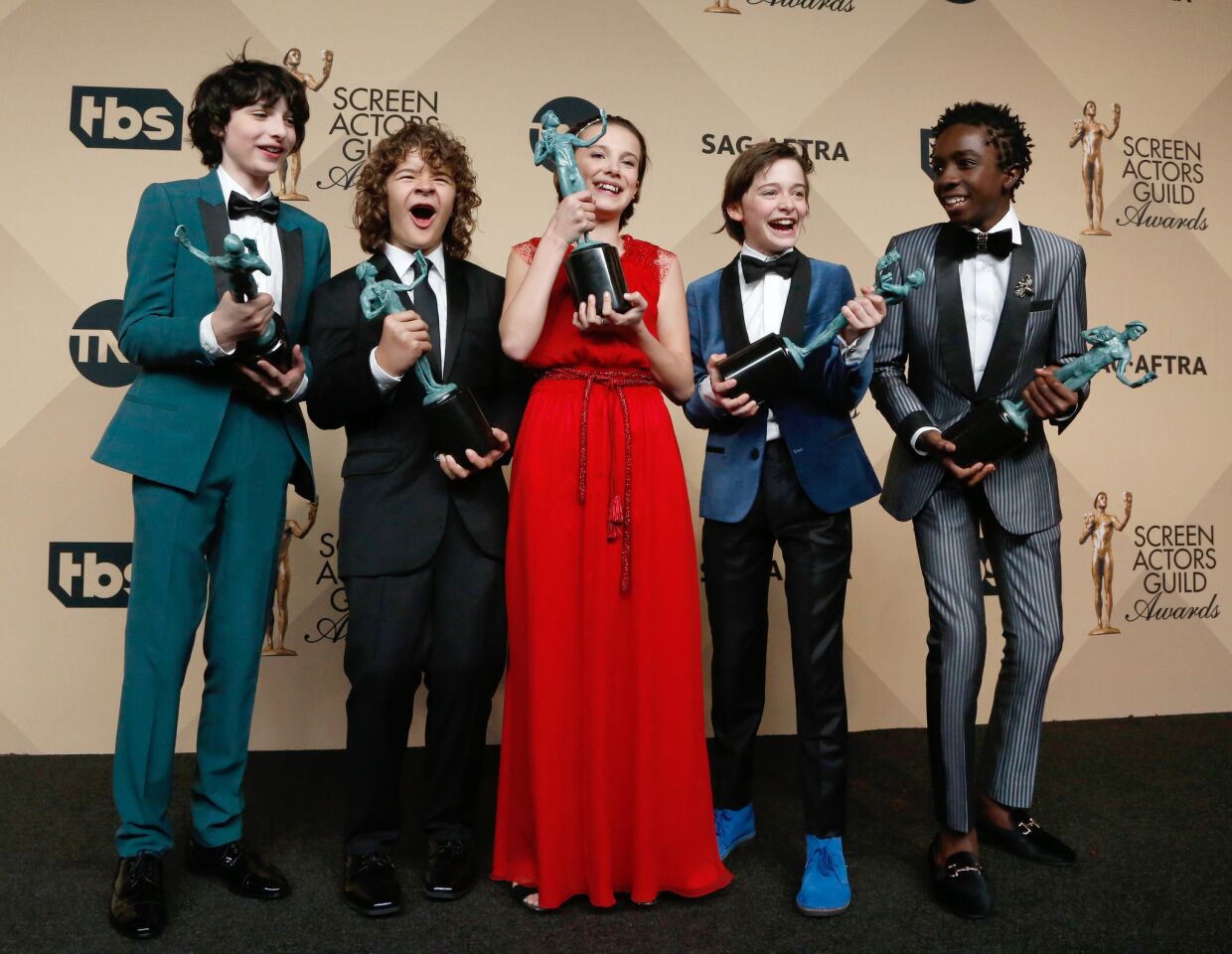 Finn Wolfard, left, Gaten Matarazzo, Millie Bobby Brown, Noah Schapp and Caleb McLaughlin, winners of ensemble in a drama series for "Stranger Things."
