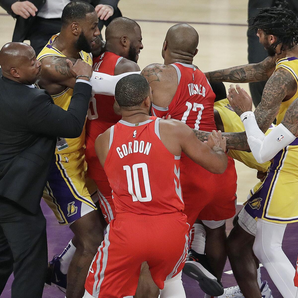 Players try to separate Chris Paul and Rajon Rondo after Paul appeared to poke Rondo in the face as they exchanged words on Saturday at Staples Center.