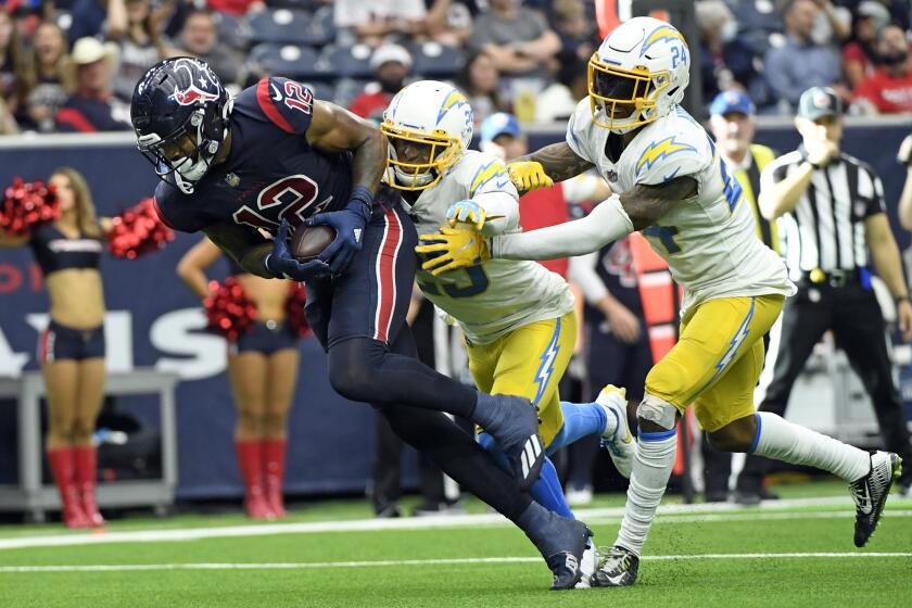 Houston Texans wide receiver Nico Collins (12) catches a pass for a touchdown as Los Angeles Chargers.