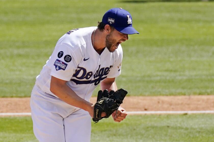 Los Angeles Dodgers starting pitcher Clayton Kershaw celebrates after striking out Washington Nationals' Jordy Mercer.