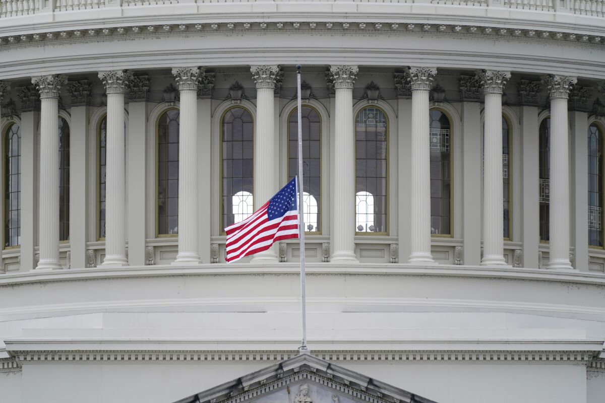 An American flag flies at half-staff above the U.S. Capitol in Washington.