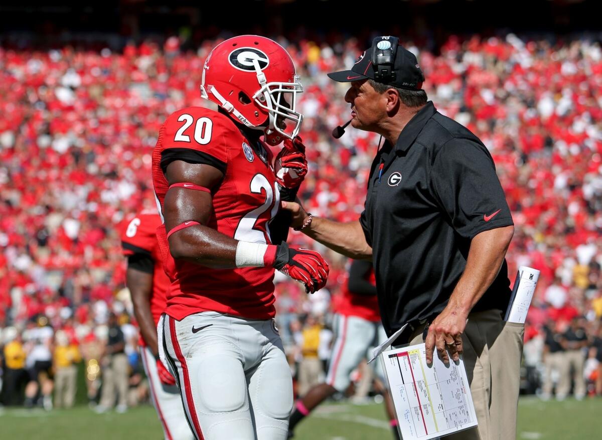 Georgia defensive end Quincy Mauger gets an earful from defensive coordinator Todd Grantham during the Bulldogs' 41-26 loss to Missouri on Saturday. The loss shattered Georgia's national title hopes.