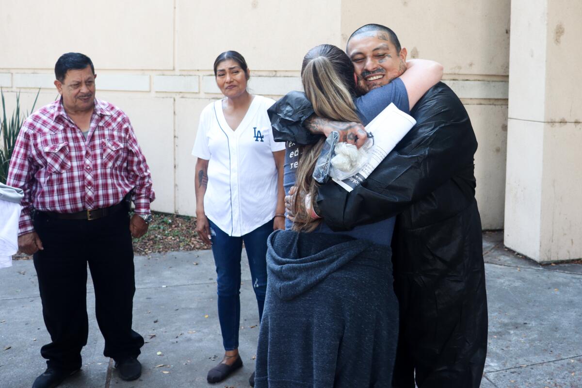 Jose Olivares hugs his attorney Lauryn Barbosa Findley.