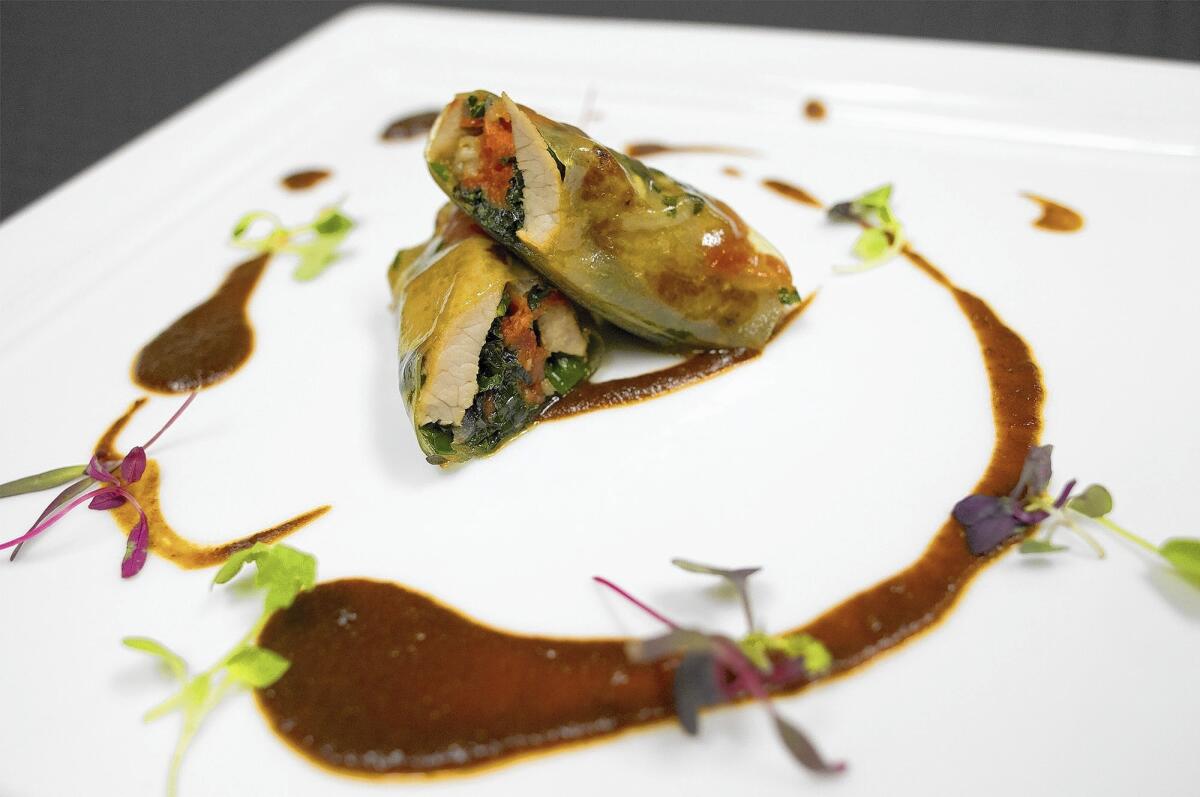 A braised veal "burrito" wrap includes leek leaves and authentic mole sauce.