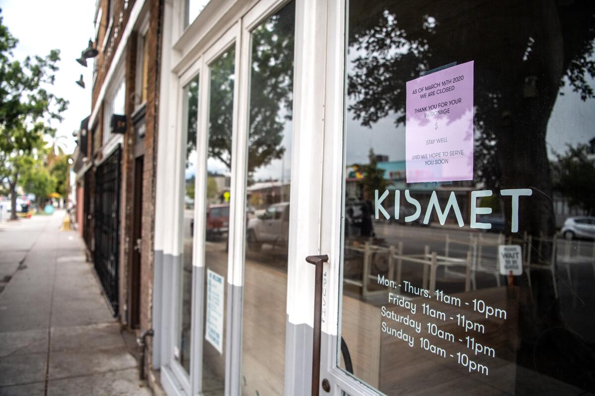 A closed sign hangs in the window of Kismet on March 20. The Los Feliz restaurant is one of many businesses that have seen their future jeopardized due to COVID-19-mandated closures.