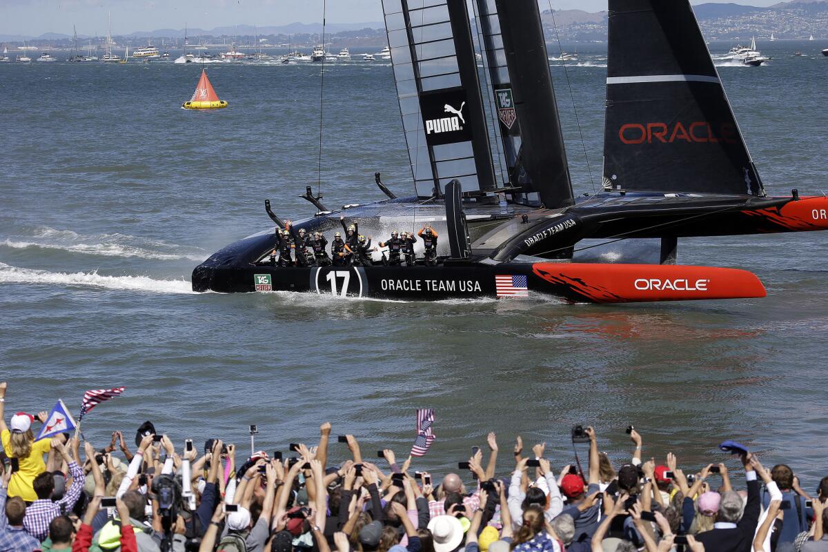 The crew on Oracle Team USA celebrates after winning the America's Cup on Sept. 25, 2013.