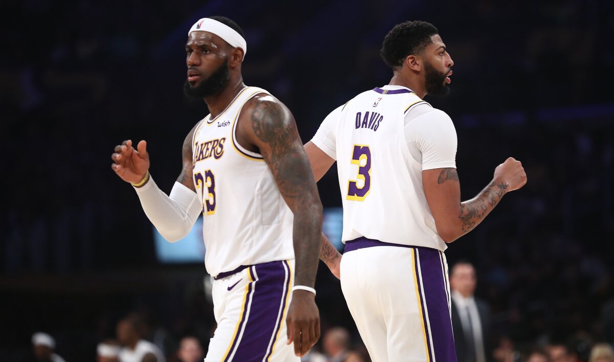 Lakers stars LeBron James and Anthony Davis play in a preseason game against the Golden State Warriors on Oct. 16.