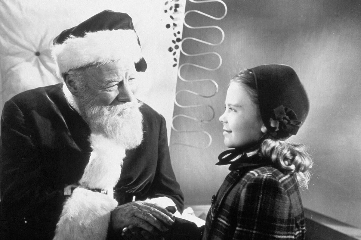 Edmund Gwenn, left, as Kris Kringle greets actress Natalie Wood in a scene from the 1947 film "Miracle on 34th Street."