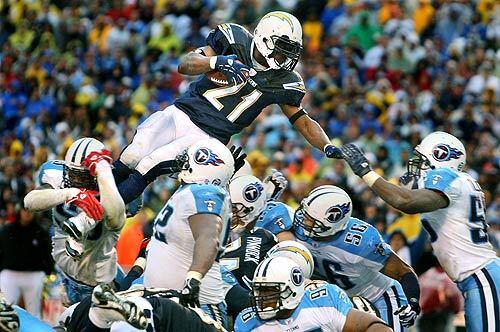 Chargers' LaDainian Tomlinson goes above the Titans for a touchdown from one yard out in the fourth quarter. San Diego beat Tennessee, 17-6, for its first playoff victory since the 1994 season.
