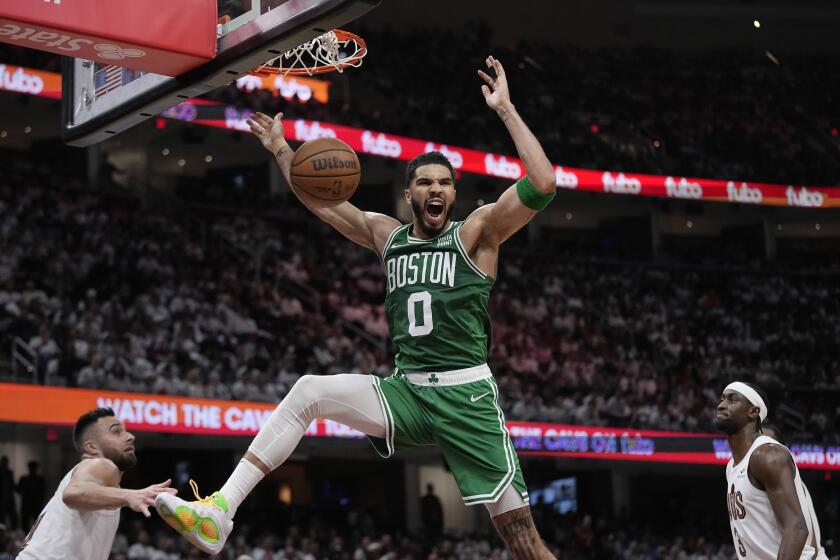 Boston Celtics forward Jayson Tatum shouts after dunking the ball 