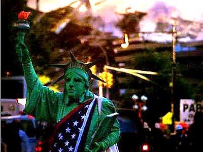 A Lady Liberty look-alike greets volunteers leaving the scene of the destruction.