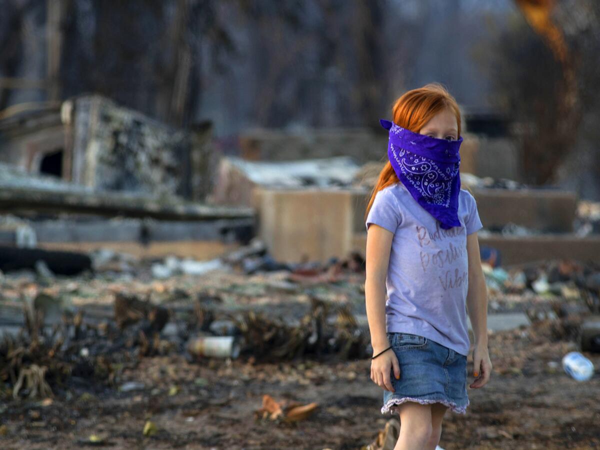 Chloe Hoskins, 7, checking on a neighbors burned out property in Coffey Park neighborhood in Santa Rosa, CA.