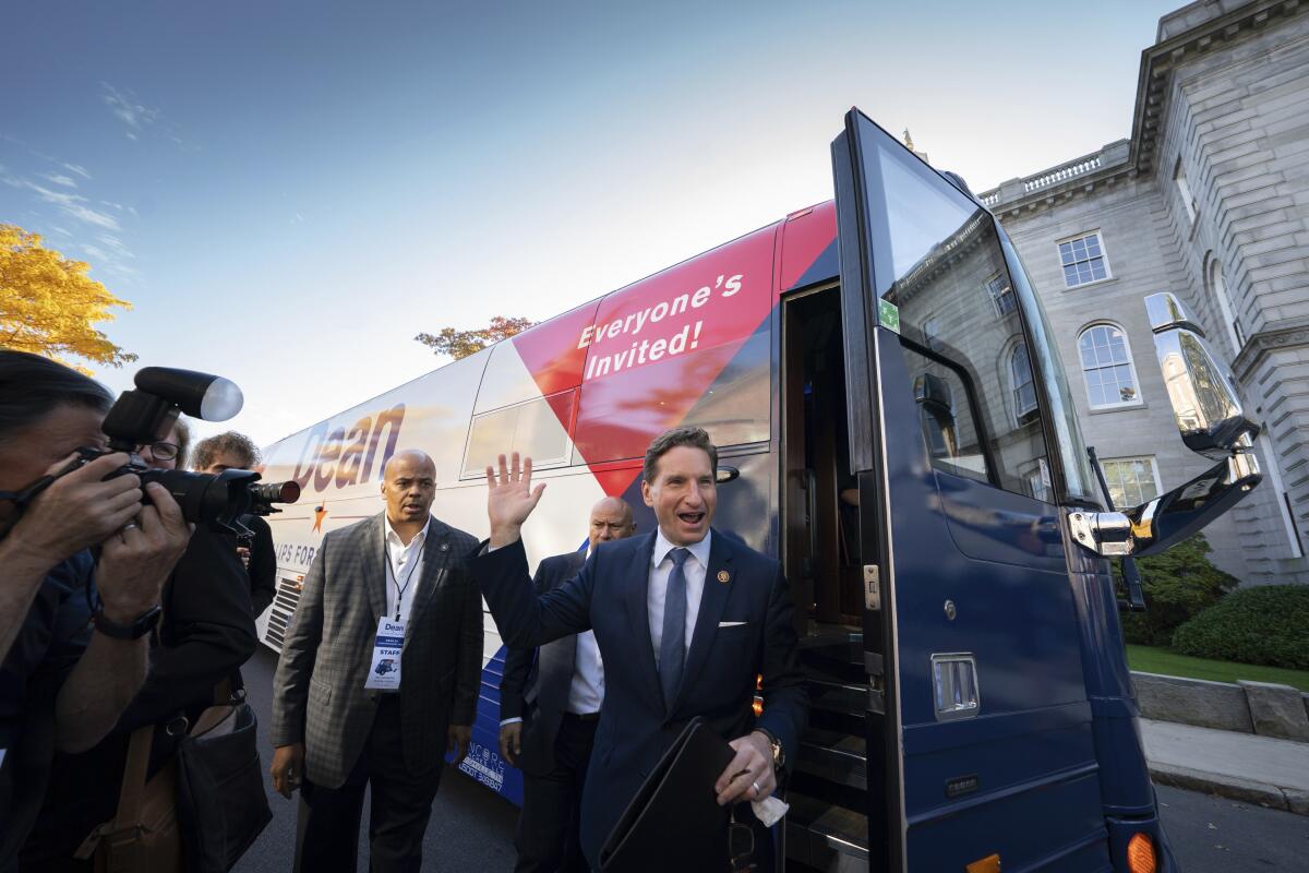 Dean Phillips waves as he steps off a campaign bus