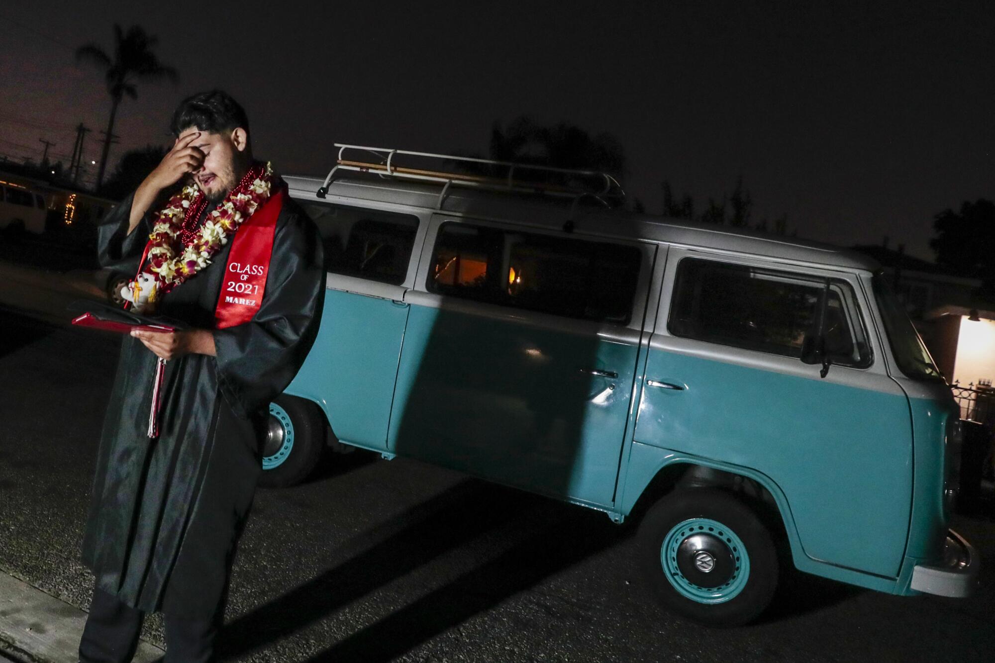 Cesar Martinez composes himself while having photos taken in front of a vintage VW van he helped his brother restore.