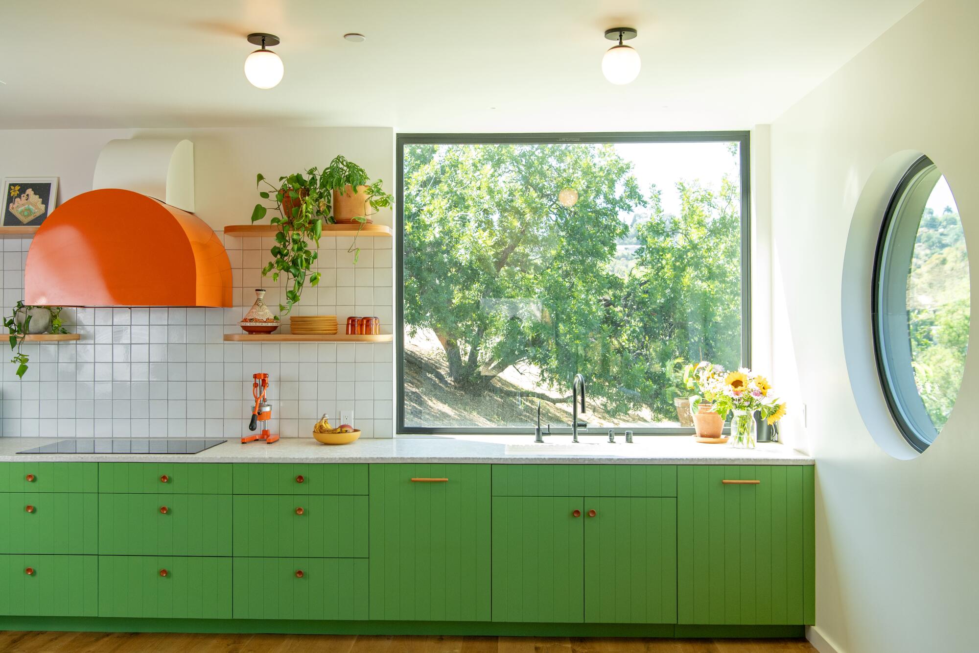 A kitchen with green cabinets
