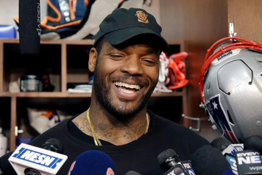 New England Patriots tight end Martellus Bennett laughs as he speaks to media at his locker after NFL football practice, Wednesday, Jan. 11, 2017, in Foxborough, Mass. (AP Photo/Elise Amendola)
