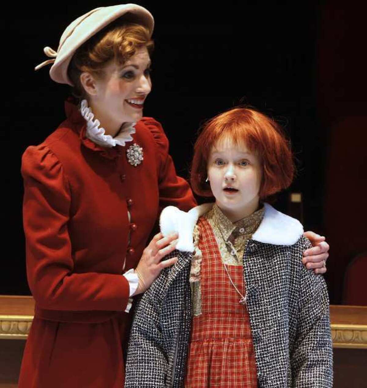 Heather Dudenbostel, as Grace, shows Annie, played by Emma Howard, her new home at a final dress rehearsal of 'Annie' at the Glendale Centre Theatre.