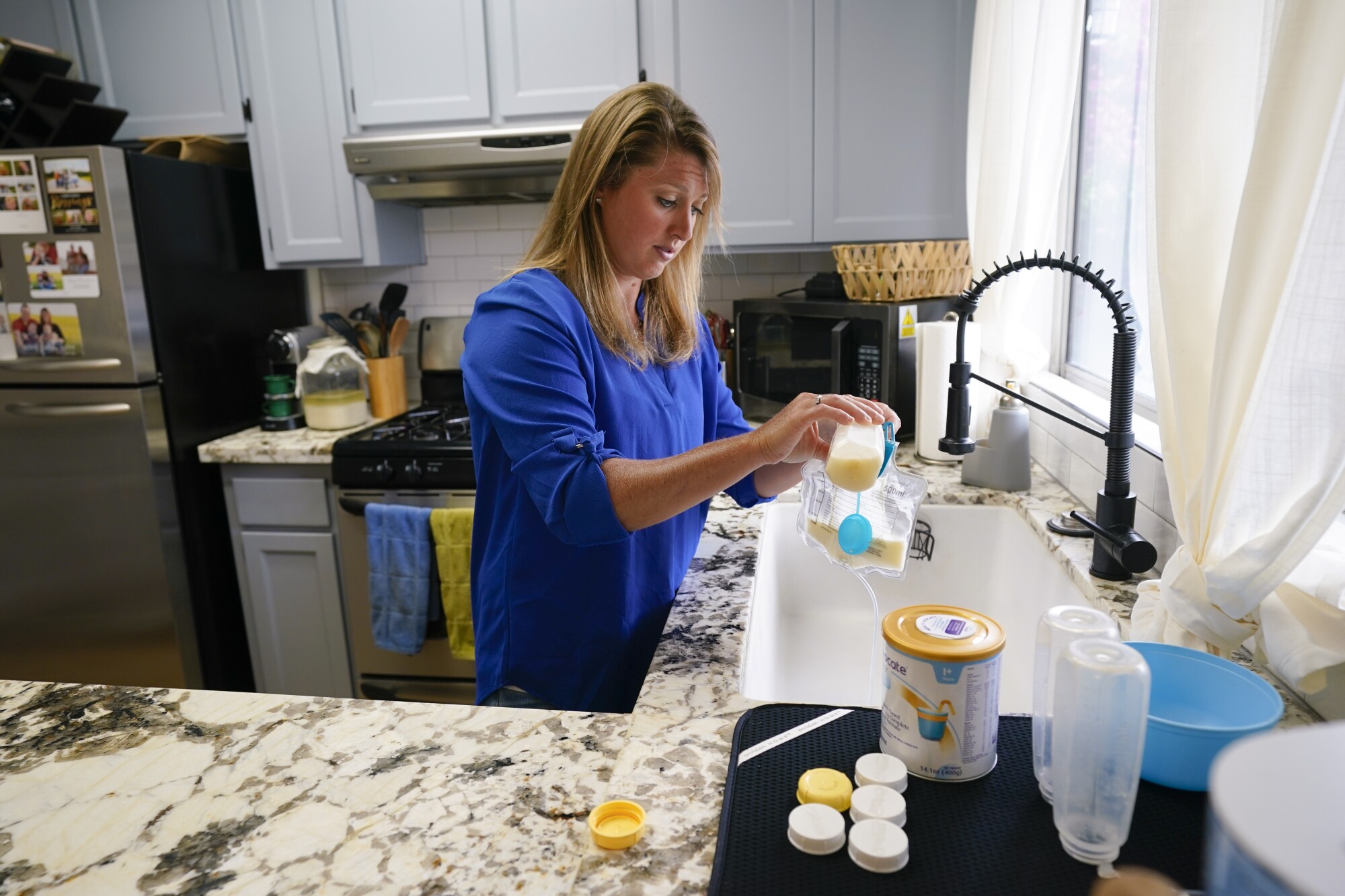 Ali Tebbs prepares her son Samuel's formula at the family home in Coronado.