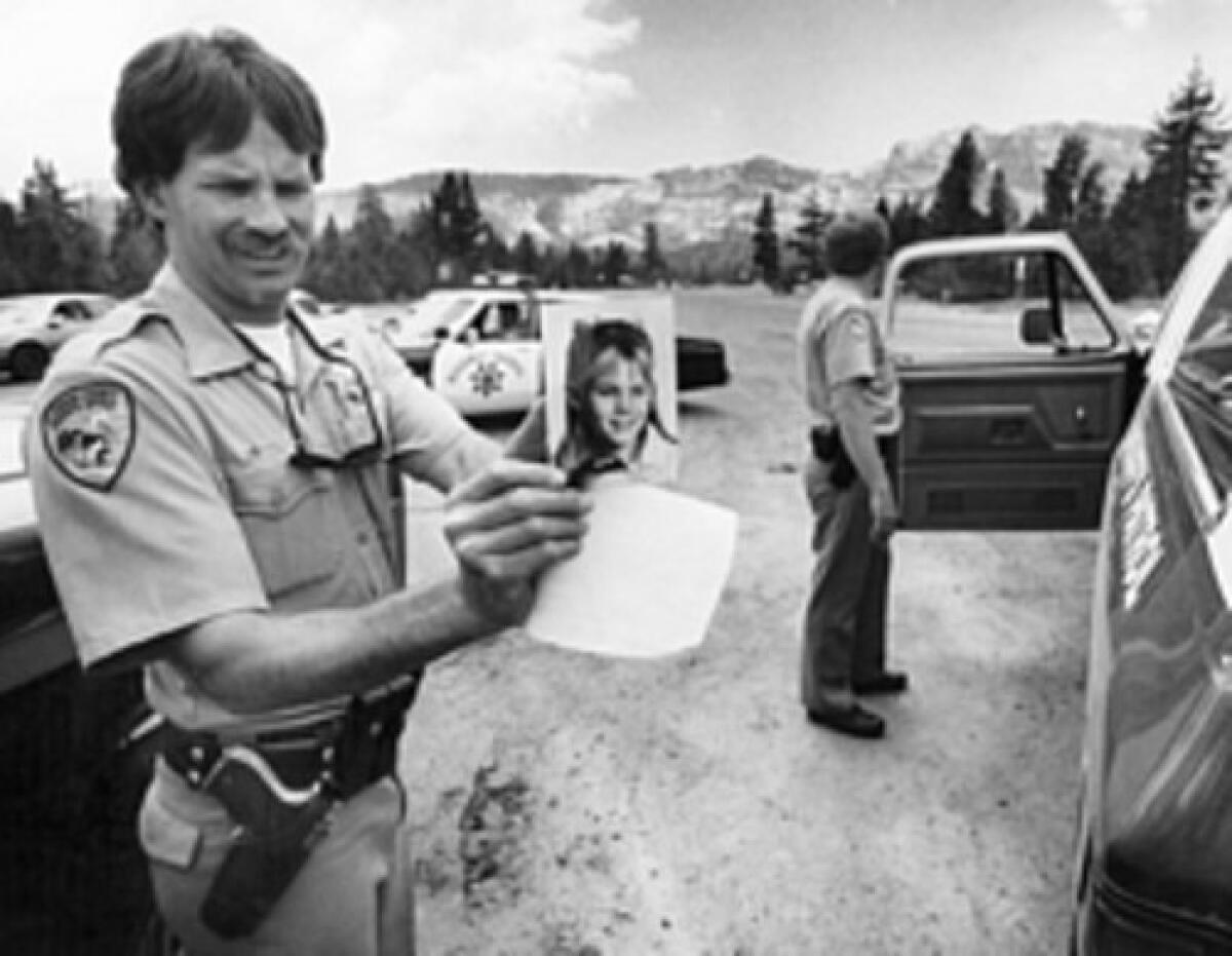 An El Dorado County sheriff's deputy holds a photo of Jaycee Lee Dugard during a search for her shortly after she was kidnapped in 1991.
