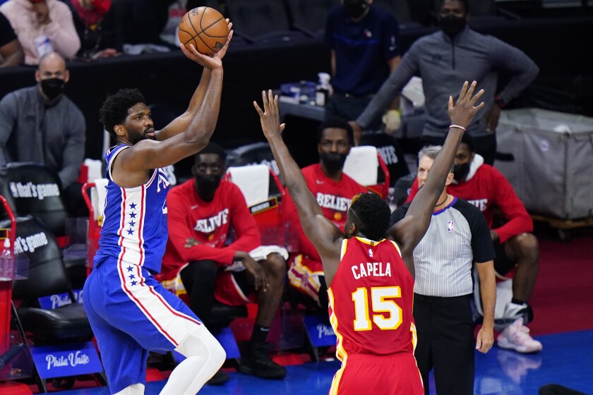 Philadelphia 76ers' Joel Embiid, left, goes up for a shot against Atlanta Hawks' Clint Capela during the second half of Game 2 in a second-round NBA basketball playoff series, Tuesday, June 8, 2021, in Philadelphia. (AP Photo/Matt Slocum)