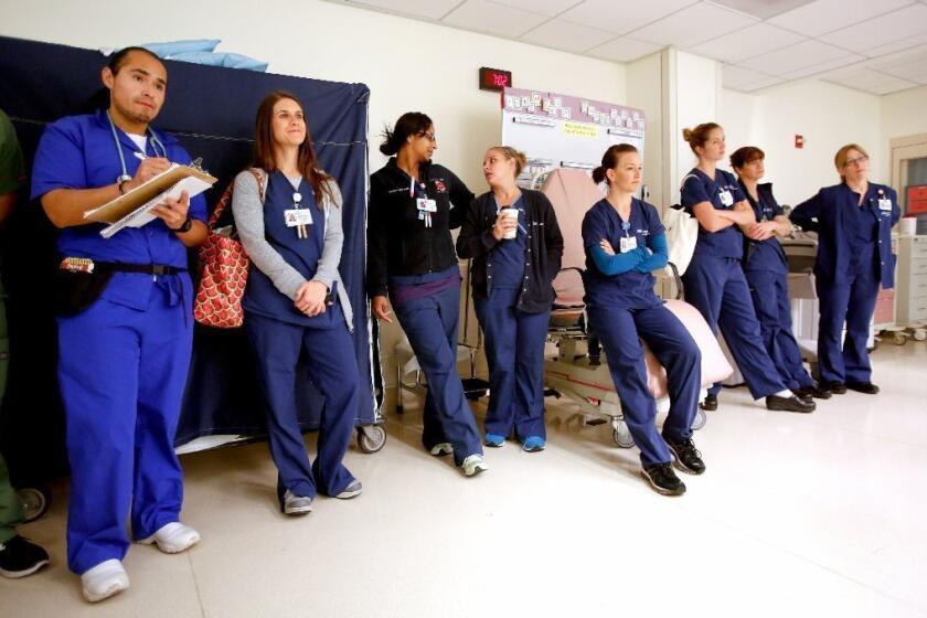 Nursing students and instructors await a shift change in the intensive care unit at UCLA Medical Center in Santa Monica. California's registered nursing board has eliminated a backlog in licensing paperwork for approximately 4,000 recent nursing graduates, state officials have reported.