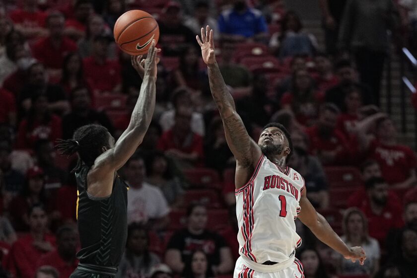 Norfolk State guard Christian Ings misses a shot under pressure from Houston guard Jamal Shead (1) during the first half of an NCAA college basketball game, Tuesday, Nov. 29, 2022, in Houston. (AP Photo/Kevin M. Cox)