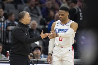 Los Angeles Clippers guard Russell Westbrook (0) talks with coach Tyron Lui during the first quarter of the team's NBA basketball game against the Sacramento Kings in Sacramento, Calif., Friday, March 3, 2023. (AP Photo/José Luis Villegas)