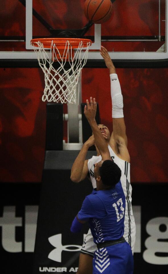 Sierra Canyon guard Amari Bailey scores on a reverse layup in front of Windward guard Jaren Harris.