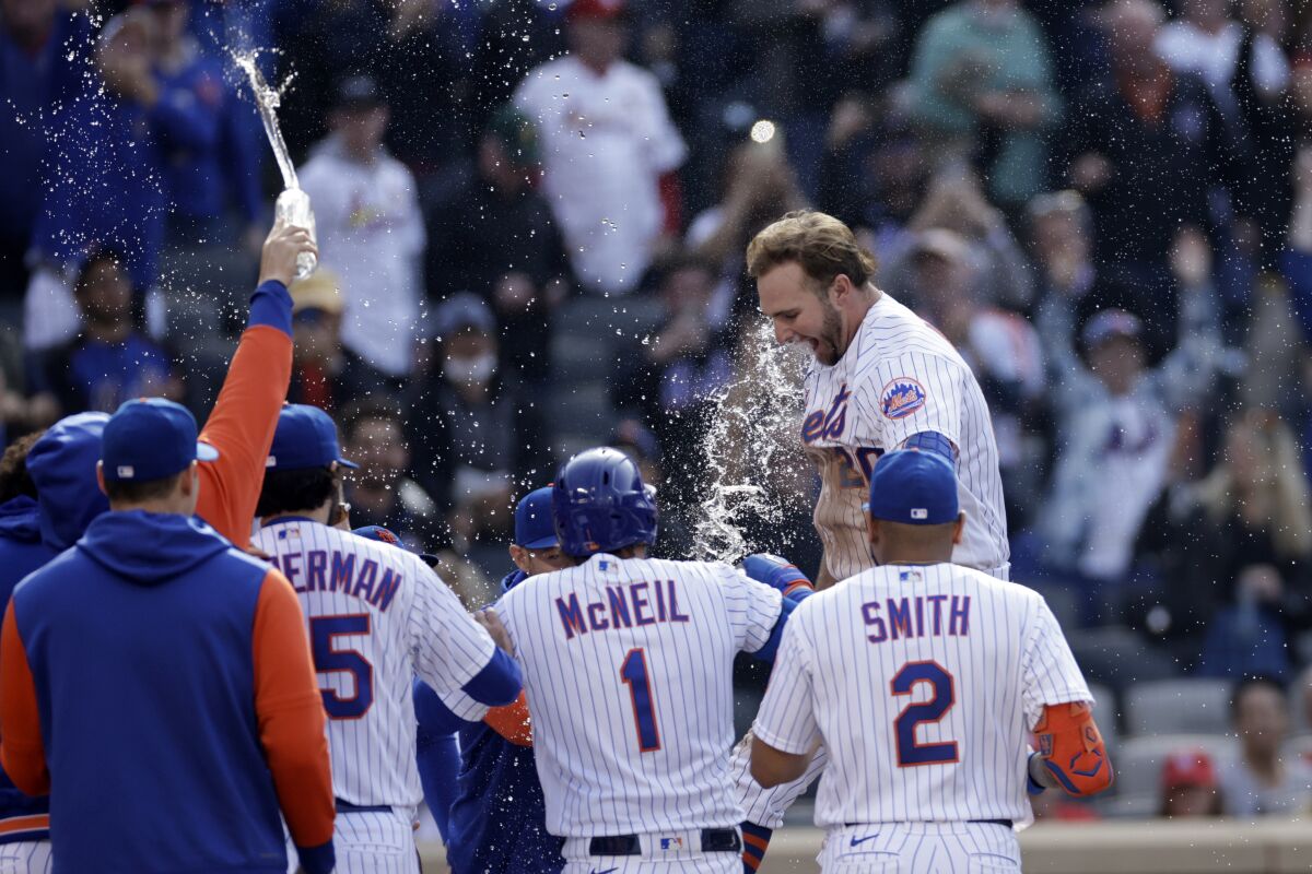New York Mets' Pete Alonso celebrates his walk-off two-run home run with teammates during the tenth inning of a baseball game against the St. Louis Cardinals on Thursday, May 19, 2022, in New York. The Mets won 7-6 in 10 innings. (AP Photo/Adam Hunger)